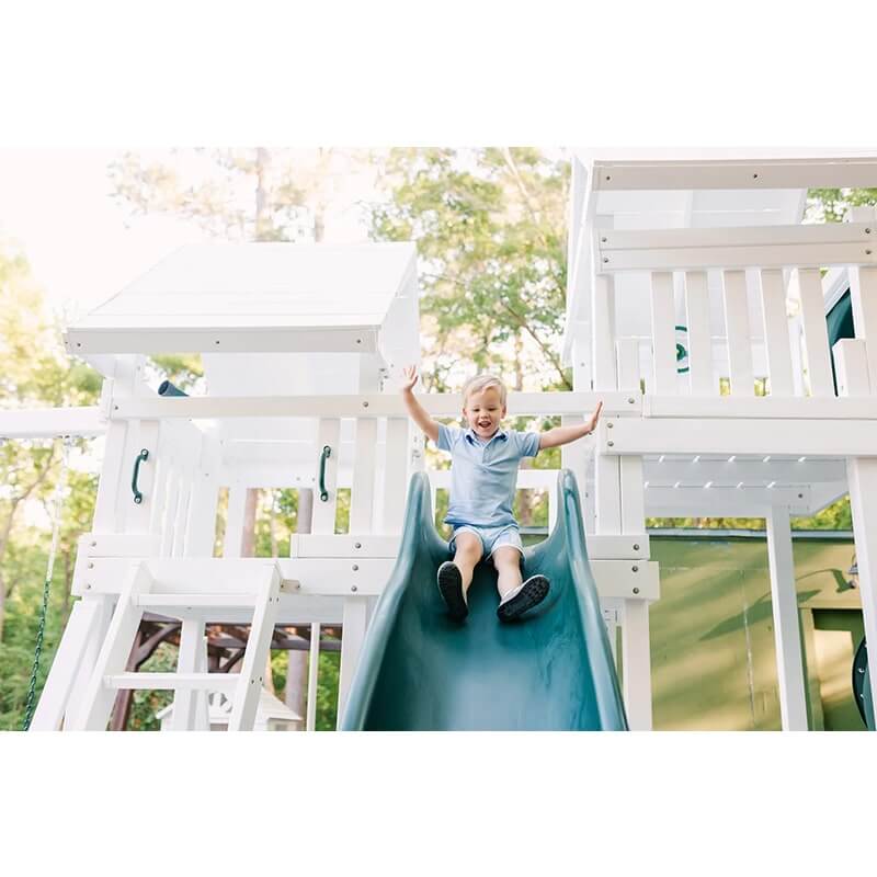 Modern playset with boy going down the slide