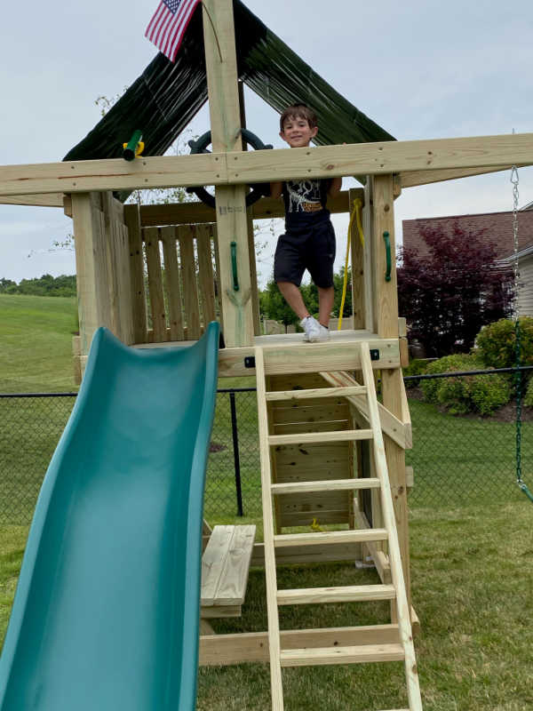 Pathfinder Swing Set: Space Saver Edition with kid in fort