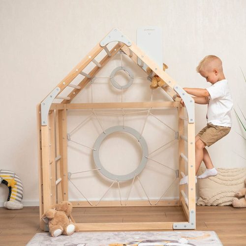 wooden climbing playhouse boy in white playing