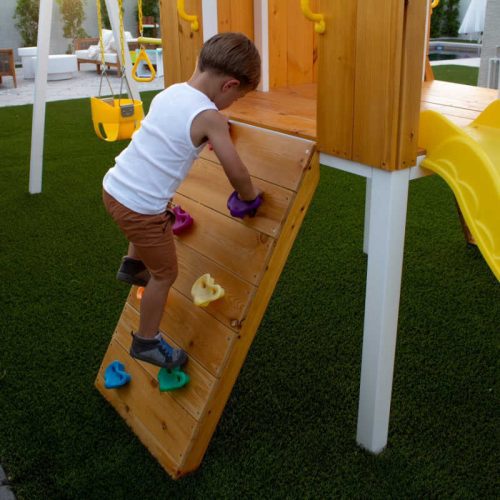 Forest ModernBackyardOutdoorSwingSetwithboyclimbingonrockwall min