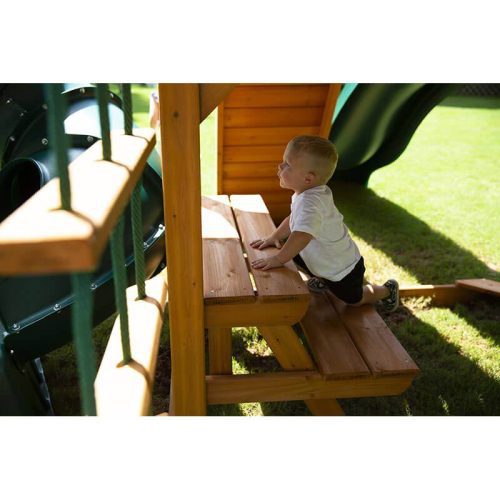 GorillaPlaysetsMountaineerSwingSetSideViewOfABoyOnThePicnicTable