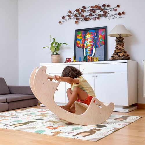 Kidodido2In1MontessoriWoodenSeesawandTableChairSetAKidSittingOnTheRightSideOfTheSeesawBalancing