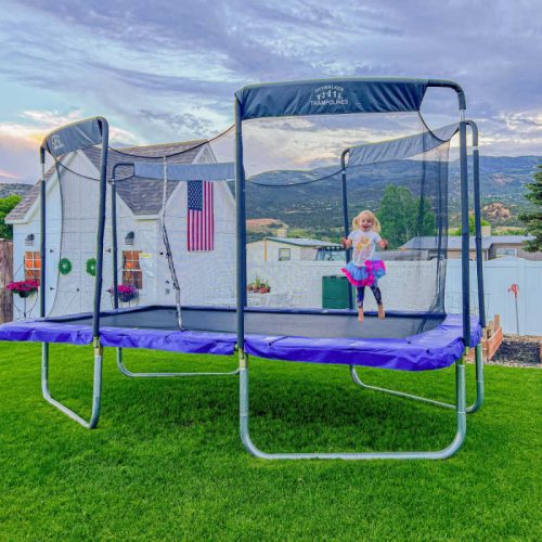 SkywalkerTrampolineMadeintheUSA17 x10 RectangleOlympic SizedPremiumTrampolinewithEnclosure LMG SPTRC1710inblueandgirljumping