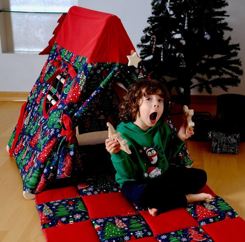 climbing triangle with christmas cover and boy