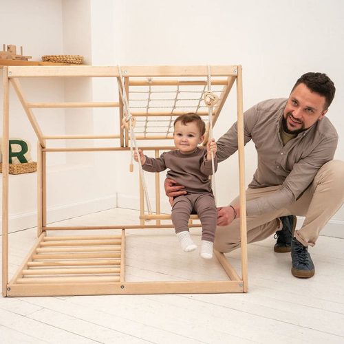 indoor jungle gym baby and father playing