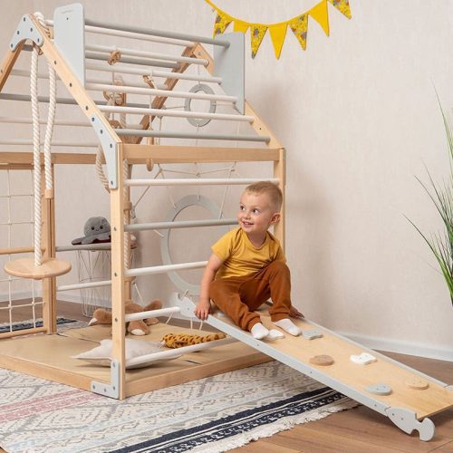 wooden climbing playhouse side view boy playing ramp